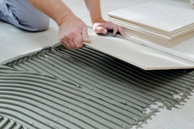 Tile adhesive being applied